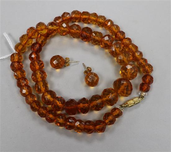 A single strand facetted amber bead necklace and a pair of matching earrings.